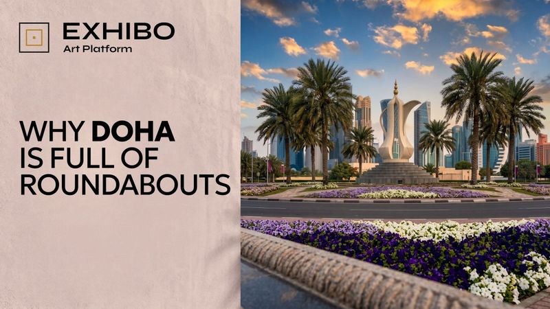 A large landscaped roundabout in Doha, Qatar, with a monumental sculpture on its central island and multi-lane traffic circling it against a backdrop of West Bay towers.