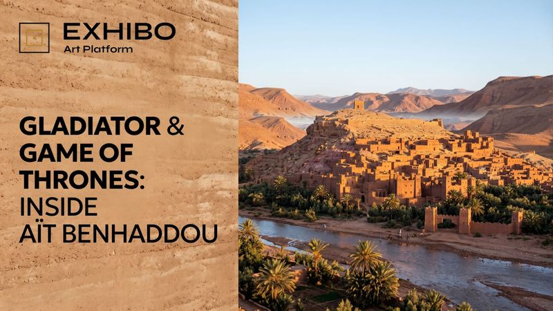 The earthen ksar of Aït Benhaddou rising in tiers up a hill above the Oued El Maleh in southern Morocco, its red-ochre towers and walls lit by low evening sun.