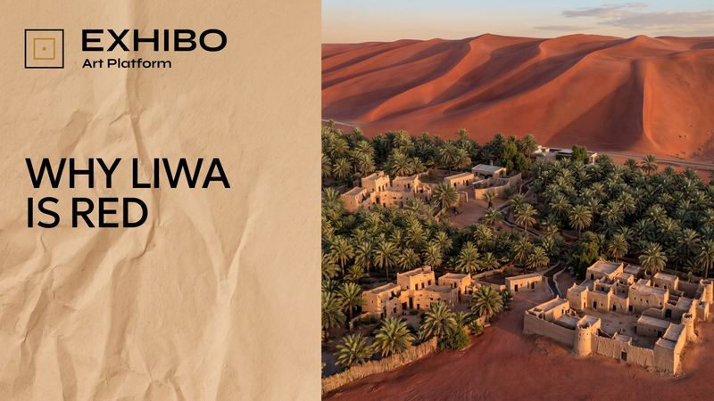 The deep rust-red mega-dunes of the Liwa crescent in the Empty Quarter, rising in smooth ridges under clear sky, with a thin line of green date palms at their base