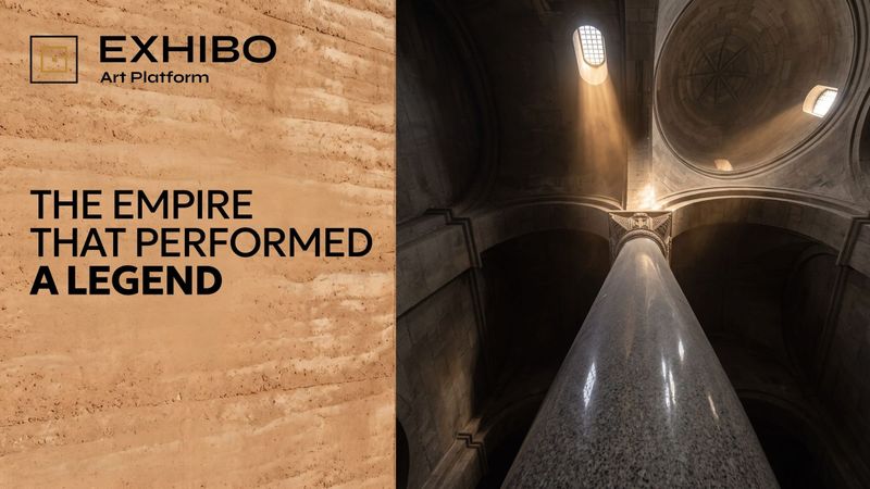 A massive granite column shaft under a stone arch, seen from below, with the dome springing above it.